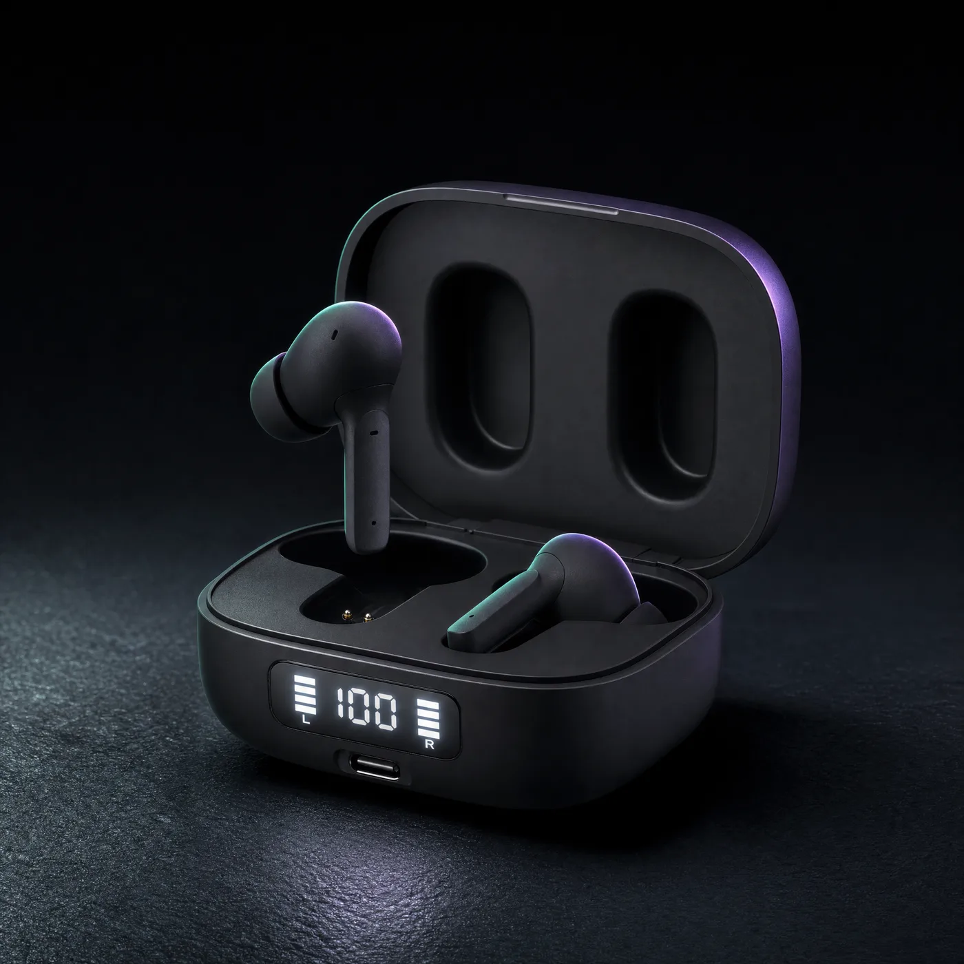The earbuds and charging case on a dark surface